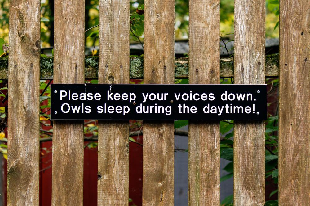 LiteSpeed Cache for WordPress and the GDPR: Sign about owl sleeping habits on a fence